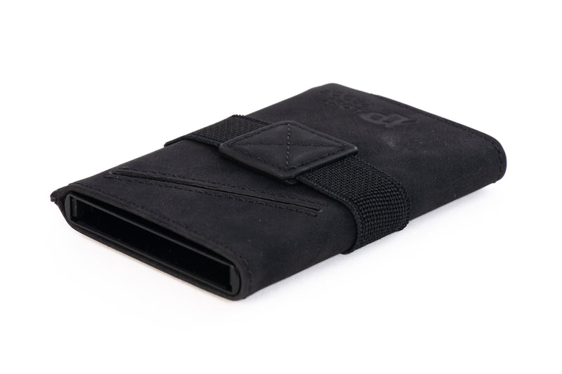 LostProof CardHold Luxe – a premium black RFID-blocking wallet with a soft leather-textured finish. The wallet features an elastic strap with a reinforced leather patch for securing cash or additional cards. The diagonal stitching adds a stylish touch, while the open bottom slot highlights its quick-access card ejector mechanism. The LostProof logo is subtly embossed on the front for a sleek and sophisticated look.