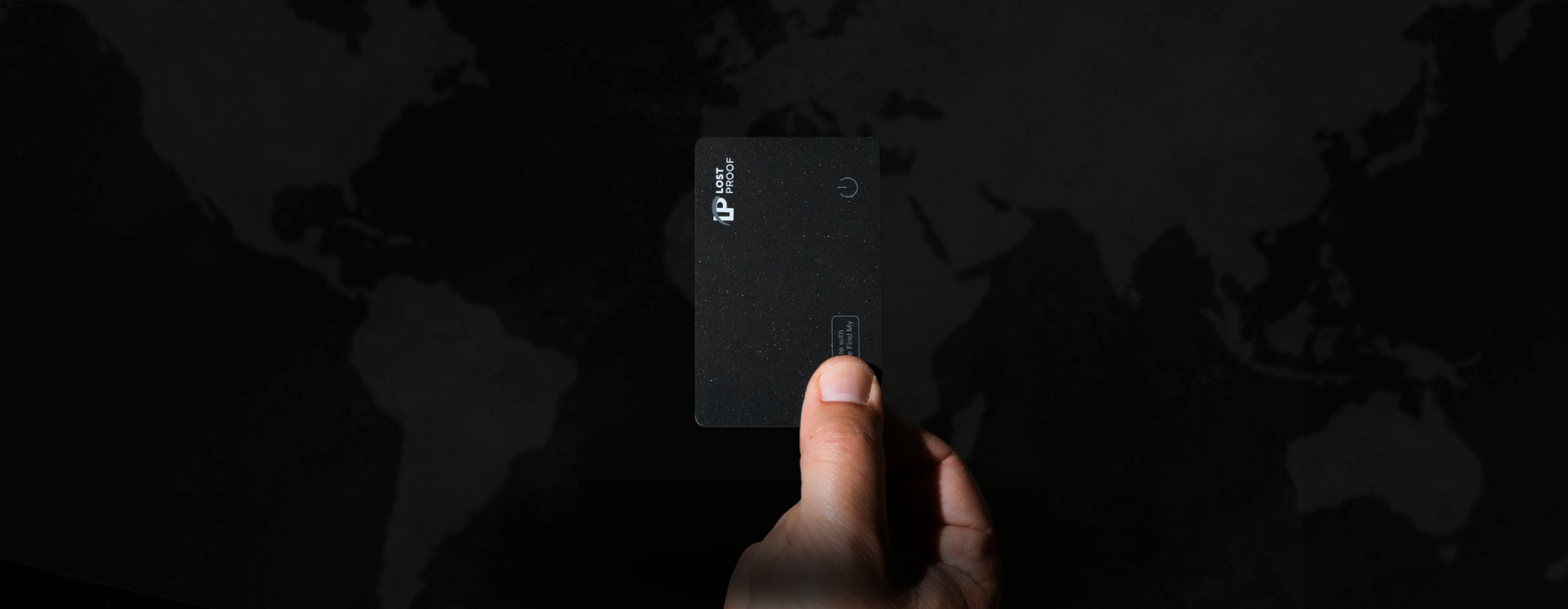 Hand holding a black wallet finder card with a dark background